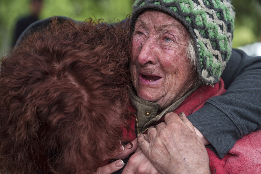 Tetiana, 82, cries with her daughter as she is evacuated from Vovchansk, Ukraine, Saturday, May 11, 2024. Her husband was killed in their house after a Russian airstrike on the city. (AP Photo/Evgeniy ...
