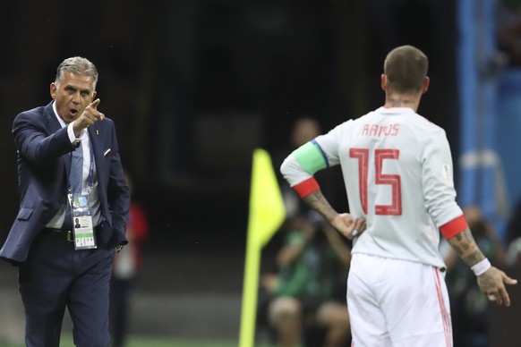 Iran head coach Carlos Queiroz, left, gestures to Spain&#039;s Sergio Ramos during the group B match between Iran and Spain at the 2018 soccer World Cup in the Kazan Arena in Kazan, Russia, Wednesday, ...