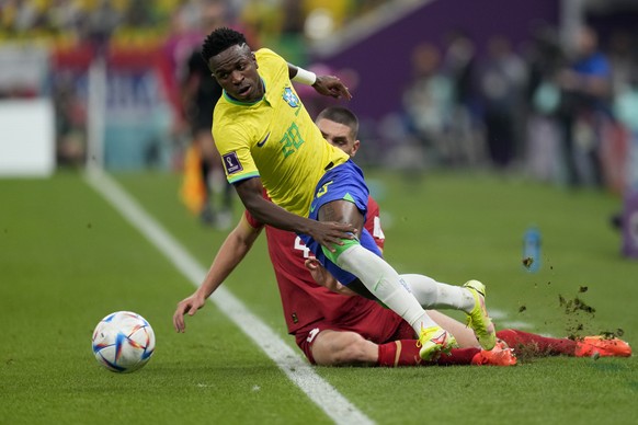 Serbia&#039;s Nikola Milenkovic tries to tackle Brazil&#039;s Vinicius Junior during the World Cup group G soccer match between Brazil and Serbia, at the Lusail Stadium in Lusail, Qatar, Thursday, Nov ...