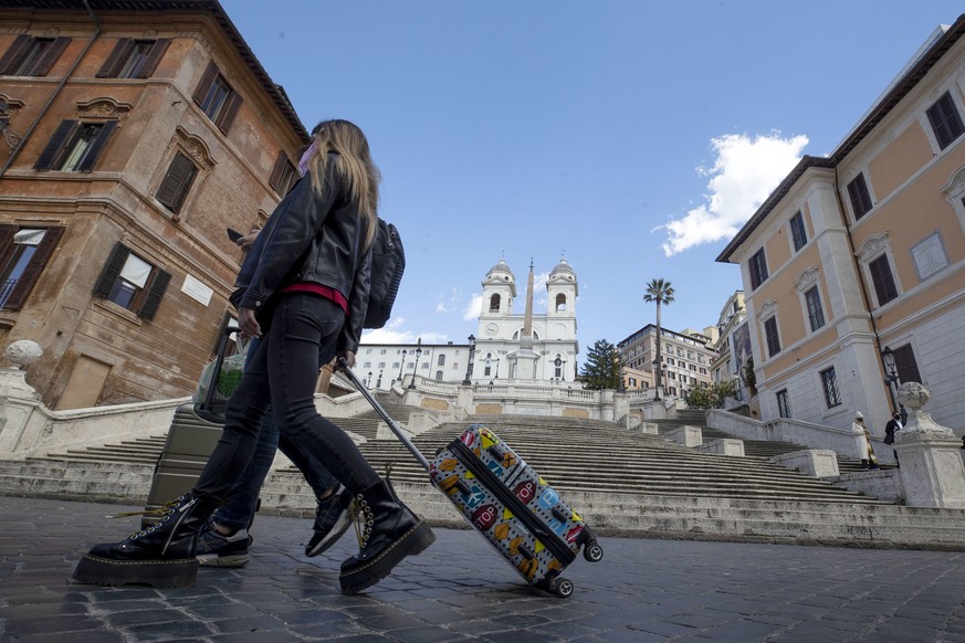 epa09076658 A person walks in the streets of the semi-deserted city center on the first day of the entry into force of the new measures against the Covid-19 pandemic adopted by the government, in Rome ...