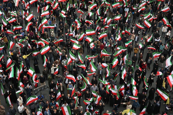 epaselect epa12783542 Iranian gather during anti-US and Israeli protests in Tehran, Iran, 28 February 2026. A joint Israeli and US military operation targeted multiple locations across Iran in the ear ...