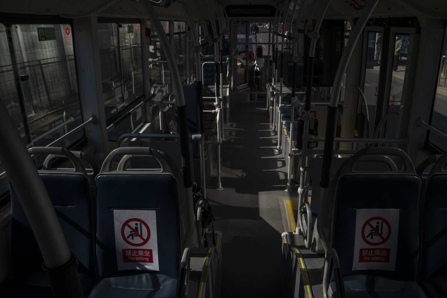 An empty bus, part of the bubble created for the 2022 Winter Olympics, Tuesday, Feb. 8, 2022, in Beijing. (AP Photo/Nariman El-Mofty)