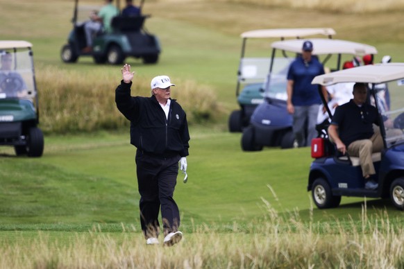 FILE - In this July 14, 2018, file photo, U.S. President Donald Trump waves to protesters while playing golf at Turnberry golf club in Turnberry, Scotland, Britain. The White House on Thursday, Feb. 1 ...