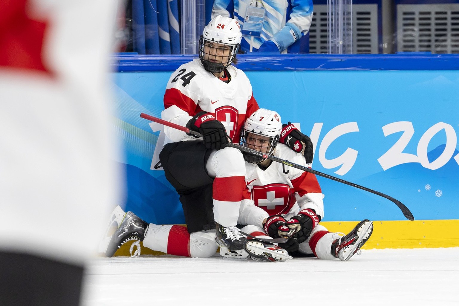 Switzerland&#039;s forward Lara Stalder, right, is comforted by Switzerland&#039;s forward Noemi Ryhner, left, after losing the women&#039;s ice hockey Bronze Medal game between Finland and Switzerlan ...