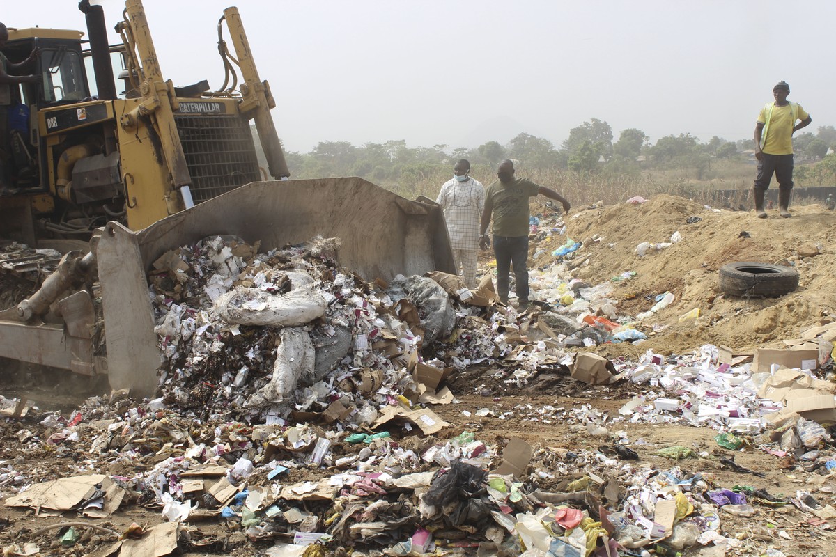 Expired COVID-19 vaccines are being destroyed by government officials in Abuja, Nigeria. Wednesday, Dec. 22, 2021. Nigeria destroyed more than 1 million expired doses of AstraZeneca's COVID-19 va ...
