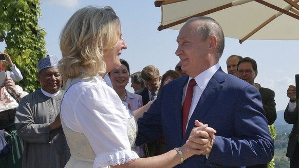 Russian President Vladimir Putin, right, congratulates Austrian Foreign Minister Karin Kneissl as he attends the wedding of Kneissl with Austrian businessman Wolfgang Meilinger in Gamlitz, southern Au ...