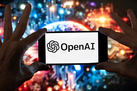 FILE - The OpenAI logo is displayed on a cell phone in front of an image generated by ChatGPT's Dall-E text-to-image model, Dec. 8, 2023, in Boston. (AP Photo/Michael Dwyer, File)
OpenAI