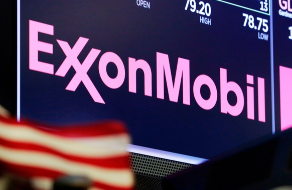 FILE - In this April 23, 2018 file photo, the ExxonMobil logo appears above a trading post on the floor of the New York Stock Exchange.  Exxon Mobil shareholders have fired a third board member…