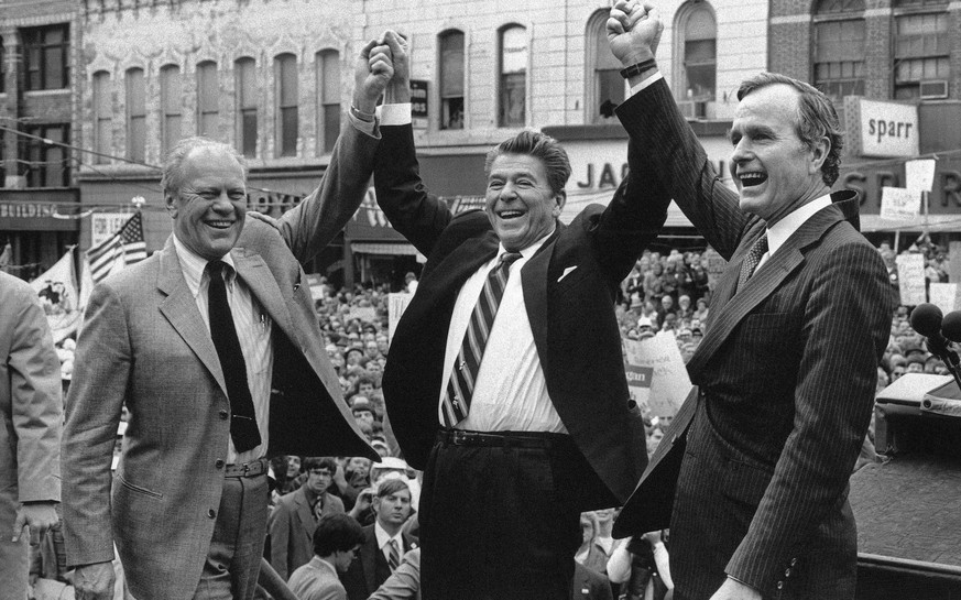 FILE - In this Nov. 3, 1980, file photo, former President Gerald Ford lends his support to Republican presidential candidate Ronald Reagan and his running mate, George H.W. Bush in Peoria, Ill. Bush h ...