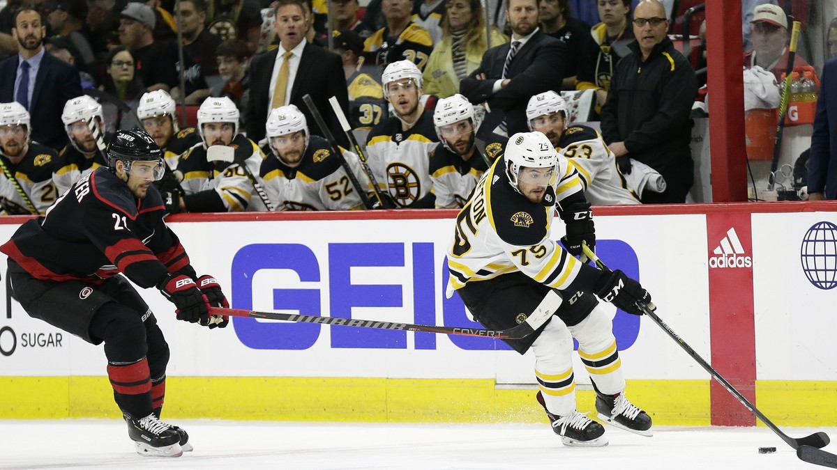 Boston Bruins' Connor Clifton controls the puck while Carolina Hurricanes' Nino Niederreiter (21), of Switzerland, defends during the first period in Game 3 of the NHL hockey Stanley Cup Eas ...