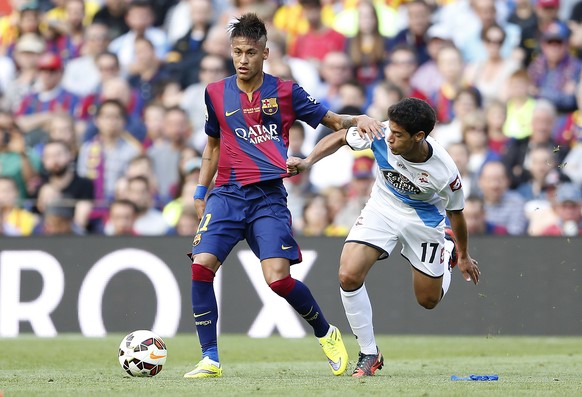 FC Barcelona&#039;s Neymar, left, duels for the ball against Deportivo Coruna&#039;s Diogo Salomao during a Spanish La Liga soccer match at the Camp Nou stadium in Barcelona, Spain, Saturday, May 23,  ...