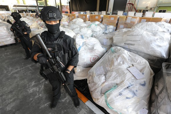 epa11044545 Thai police special forces officers stand guard next to boxes of confiscated illegal drugs during the incinerating of seized narcotics ceremony, to mark the government&#039;s wars on drugs ...
