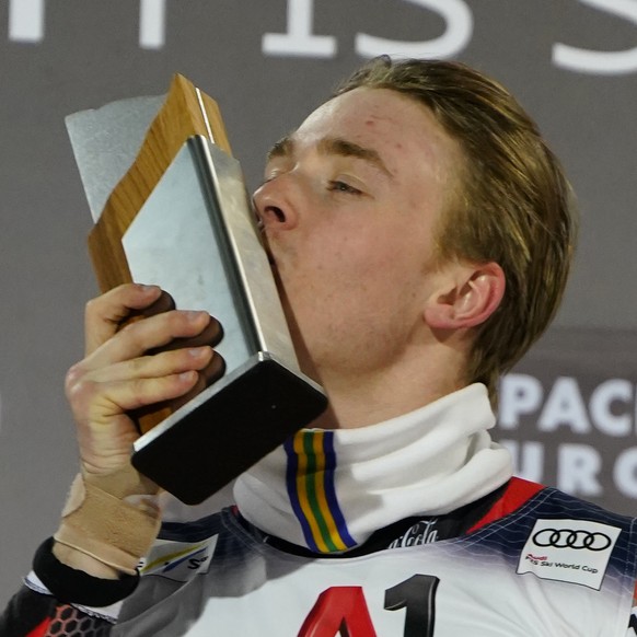 The winner Norway&#039;s Atle Lie McGrath celebrates on podium after completing an alpine ski, men&#039;s World Cup slalom race, in Flachau, Austria, Wednesday, March 9, 2022. (AP Photo/Piermarco Tacc ...