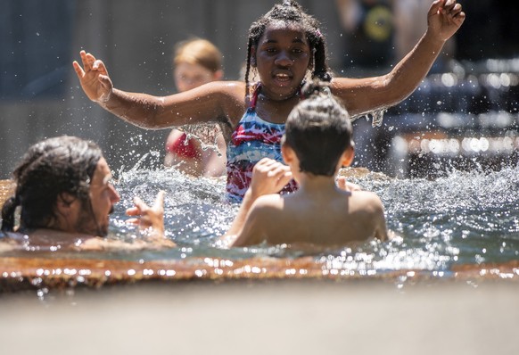 While the city reached a record temperature of over 110 degrees, people gathered at Keller Fountain Park to take a dip and cool off, Sunday, June 27, 2021, in Portland, Ore. (Mark Graves/The Oregonian ...