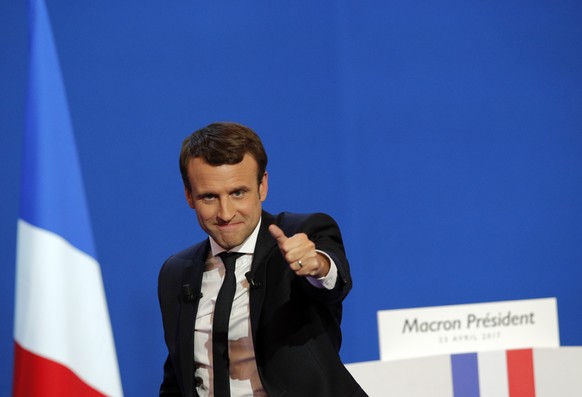 French centrist presidential candidate Emmanuel Macron thumbs up as he addresses his supporters at his election day headquarters in Paris , Sunday April 23, 2017. Macron and far-right populist Marine  ...