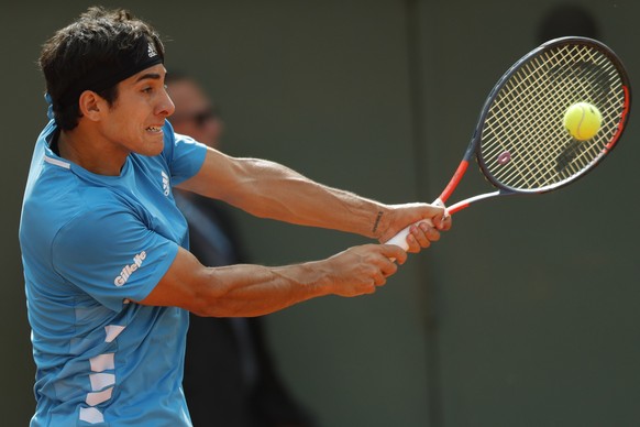 Chile&#039;s Cristian Garin plays a shot against Switzerland&#039;s Stan Wawrinka during their second round match of the French Open tennis tournament at the Roland Garros stadium in Paris, Wednesday, ...