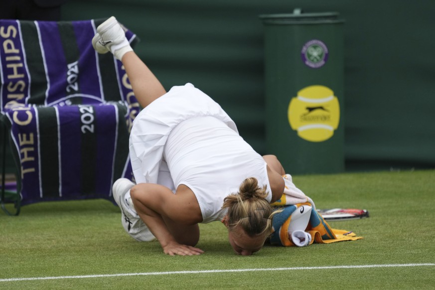 Switzerland&#039;s Viktorija Golubic kisses the grass after winning the women&#039;s singles fourth round match against Madison Keys of the US on day seven of the Wimbledon Tennis Championships in Lon ...