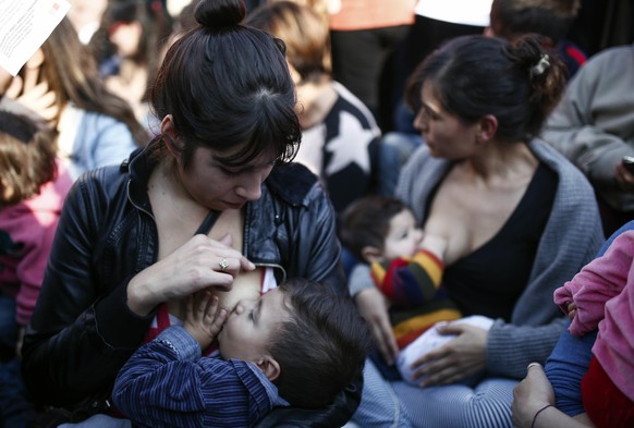 Women breastfeed during a demonstration in support of breastfeeding in public, in Buenos Aires, Argentina, Saturday, July 23, 2016. The rally was organized after a woman was ejected last week from a p ...