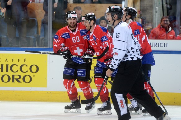 Team Suisse player Tristan Scherwey and Simon Bodenmann celebrates after scoring 1:0 during the game between Team Suisse and Haemeenlinna PK at the 91th Spengler Cup ice hockey tournament in Davos, Sw ...