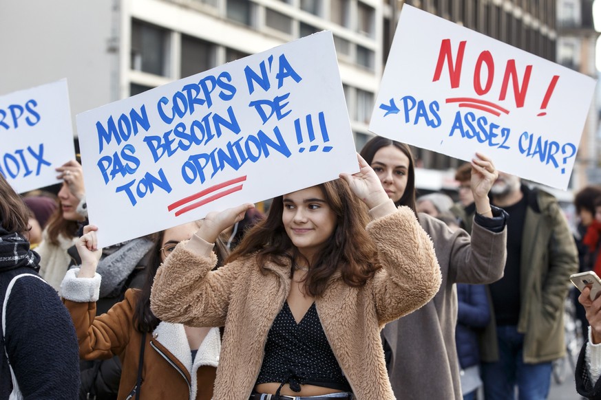 epa07187455 People demonstrate holding placards reading &#039;my body does not need your opinion&#039; and &#039;No not enough specific&#039;, during a demonstration against violence towards women on  ...