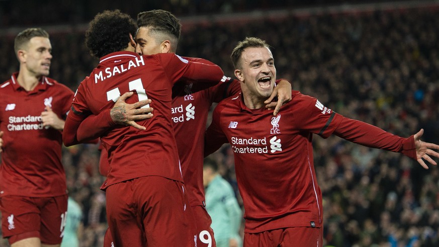 epa07253406 Liverpool&#039;s Roberto Firmino is congratulated by Mohamed Salah and Xherdan Shaqiri (R) after scoring the sixth goal in the English Premier League soccer match between Liverpool and Ars ...
