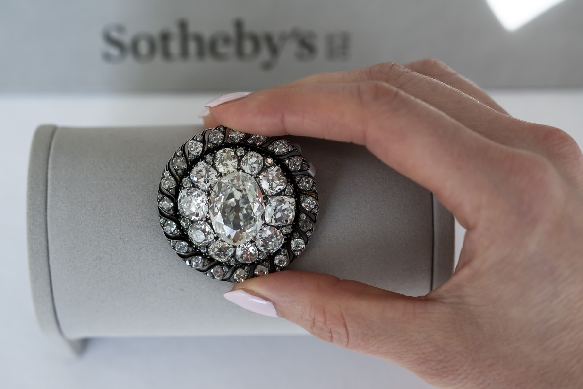 epa12507584 A Sotheby's employee displays an old mine-cut diamond brooch or pendant owned by Emperor Napoleon I, circa 1810, during a preview at Sotheby's auction house in Geneva, Switzerlan ...