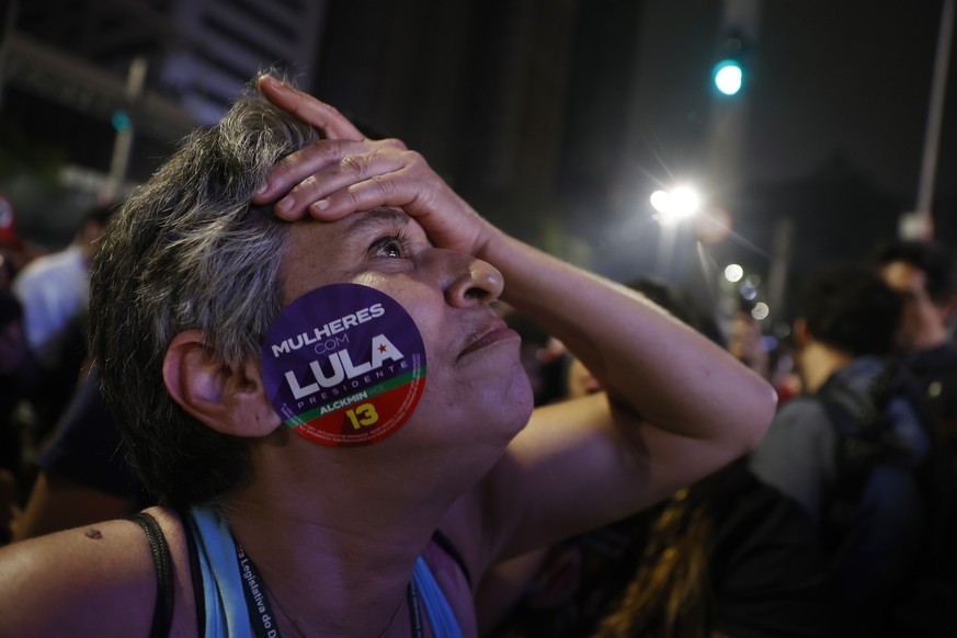 epa10220576 Supporters of former president and presidential candidate Luiz Inacio Lula da Silva celebrate while the partial results of the Brazilian elections are being announced on Paulista Avenue in ...