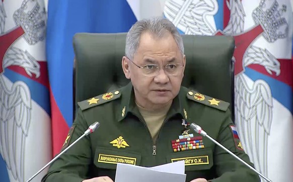 epa10702476 A handout photo made available by the Russian Defence ministry press-service shows Russian Defence Minister General of the Army Sergei Shoigu (C) delivers his speech during a meeting of th ...