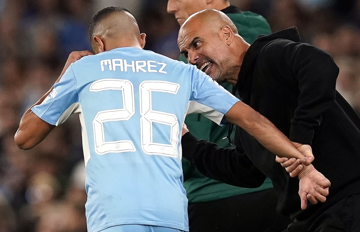 epa09470633 Manchester City's manager Pep Guardiola (R) gives instructions to Riyad Mahrez (L) during the UEFA Champions League group A soccer match between Manchester City and RB Leipzig in Manc ...