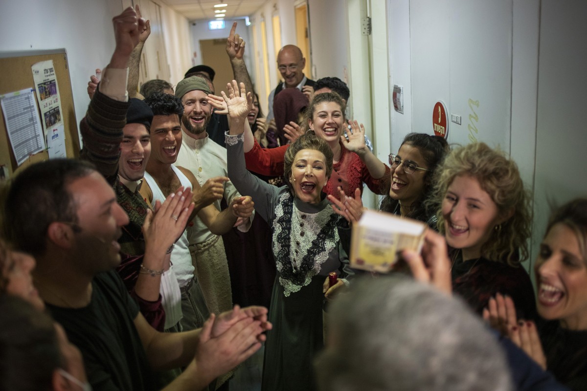 Actors cheer moments before going on stage to perform in front of vaccinated spectators at Habima, Israel's national theater, in Tel Aviv, Israel, Sunday, April 4, 2021. Israel has vaccinated ove ...