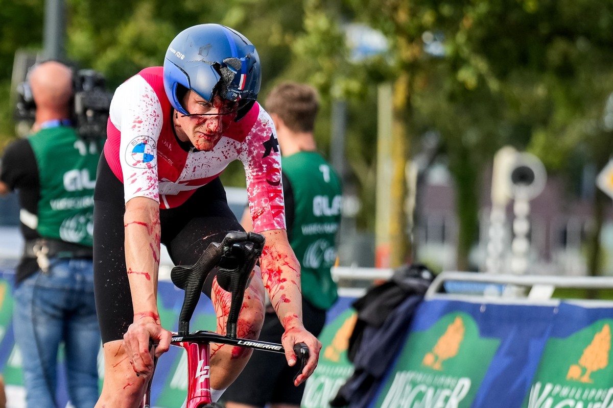 EMMEN, NETHERLANDS - SEPTEMBER 20: Stefan Kung of Switzerland finishes with a broken helmet and covered with blood after competing in the Men's Individual Time Trial of the 2023 UEC Road Cycling  ...