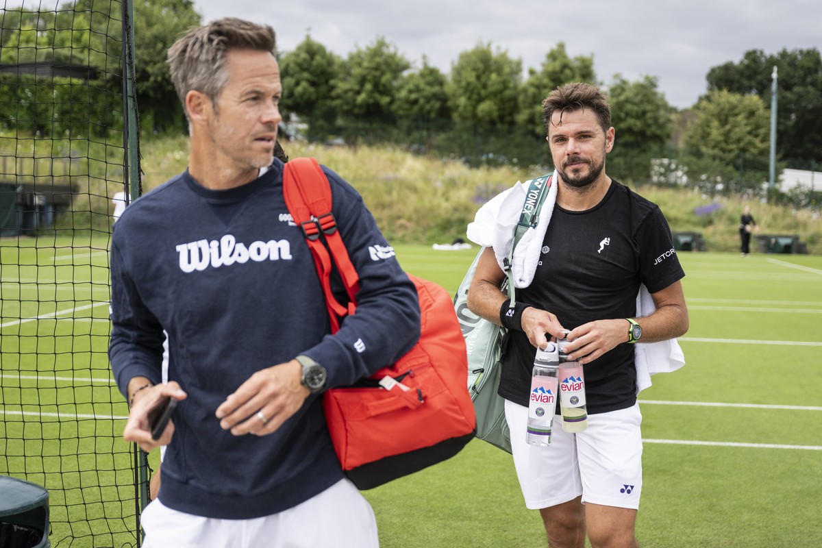 Stanislas Stan Wawrinka of Switzerland, right, with his Coach Magnus Norman of Sweden leaves the practice court after a practice session ahead of the All England Lawn Tennis Championships in Wimbledon ...