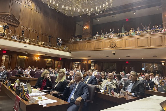 Indiana House committee members listen to testimony on its version of a Senate-approved abortion ban as listeners in an upstairs gallery of the Indiana House chamber in Indianapolis, Tuesday, Aug. 2,  ...