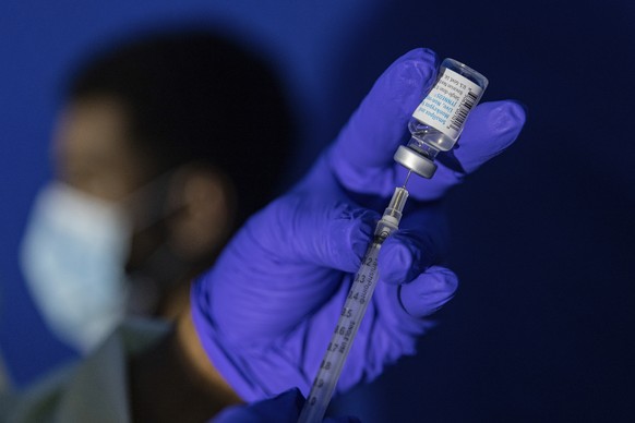 CORRECTS DAY TO TUESDAY, Family nurse practitioner Carol Ramsubhag-Carela prepares a syringe with the monkeypox vaccine before inoculating a patient at a vaccinations site on Tuesday, Aug. 30, 2022, i ...