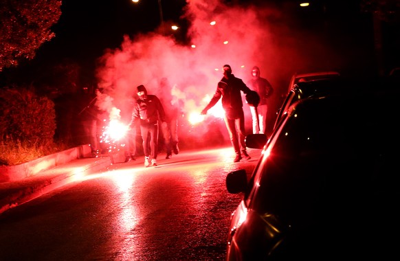 epa09064245 Demonstraters clash with riot policemen in Nea Smyrni, south district of Athens, Greece 09 March 2021. The protest was organized as a result of a footage that was shared widely on the inte ...