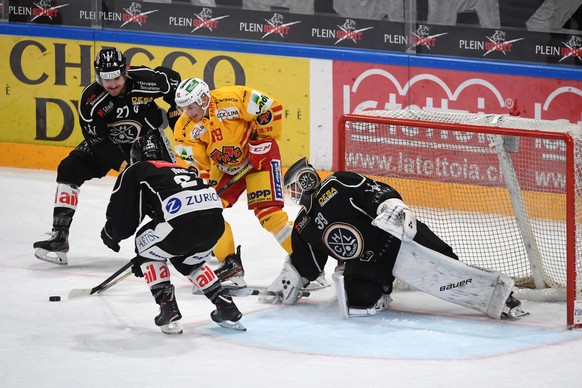 From left Lugano&#039;s player Alessandro Chiesa, Bienne&#039;s player Tino Kessler and Lugano&#039;s goalkeeper Sandro Zurkirchen during the preliminary round game of National League A (NLA) Swiss Ch ...