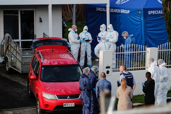 New Zealand police investigators work at a scene in Auckland on Aug. 11, 2022, after bodies were discovered in suitcases. A family who bought some abandoned goods from a storage unit in an online auct ...