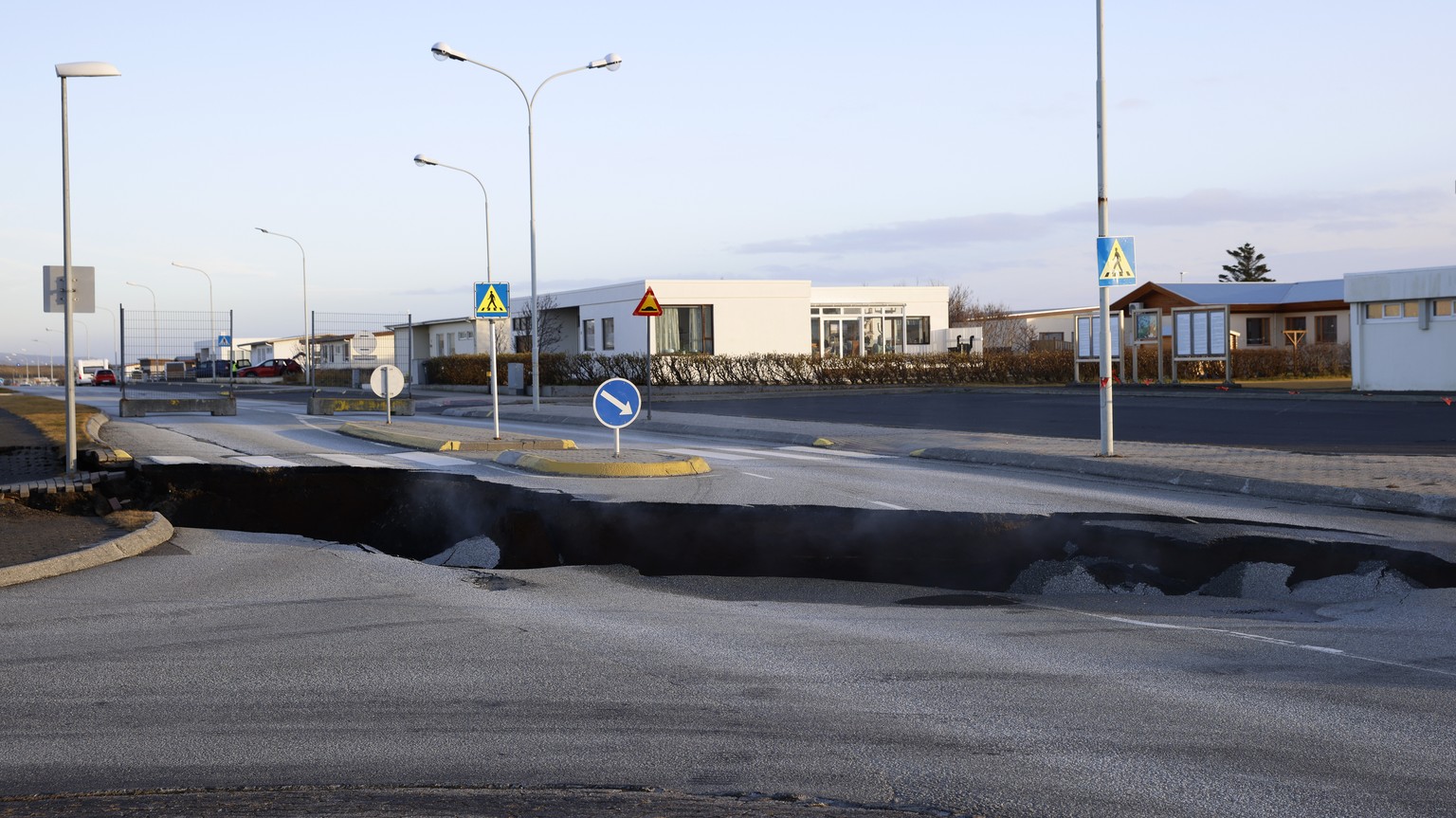 Steam rises from a fissure in a road near the town of Grindavik, Iceland Monday Nov. 13, 2023 following seismic activity. Residents of Grindavik, a town in southwestern Iceland, have been briefly allo ...
