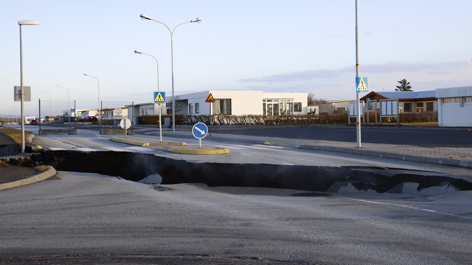 Steam rises from a crack in a road near the town of Grindavik, Iceland on Monday, November 13, 2023 due to seismic activity.  Residents of Grindavik, a city in southwestern Iceland, have been briefly assigned…