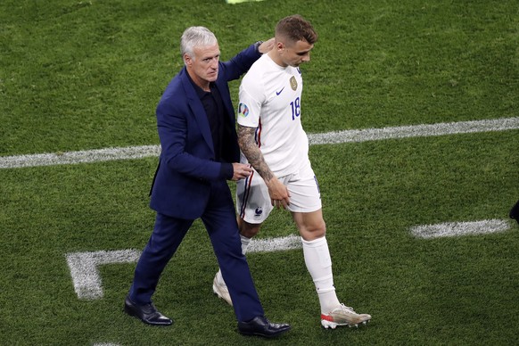 France&#039;s manager Didier Deschamps, left, greets France&#039;s Lucas Digne (18) after he was taken out of the game during the Euro 2020 soccer championship group F match between Portugal and Franc ...