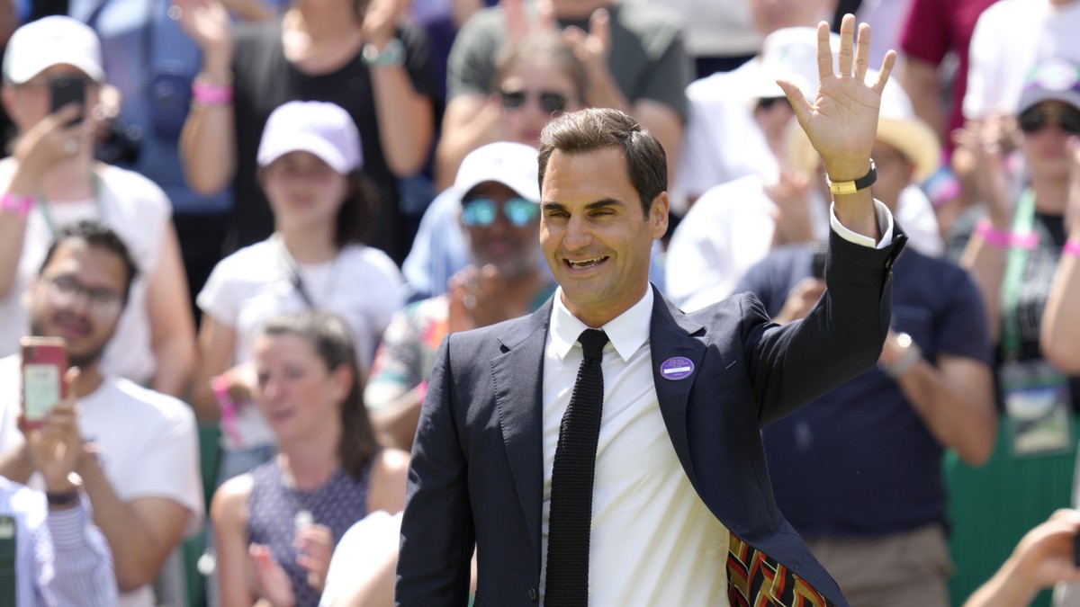 Switzerland's Roger Federer waves during a 100 years of Centre Court celebration on day seven of the Wimbledon tennis championships in London, Sunday, July 3, 2022. (AP Photo/Kirsty Wigglesworth)
