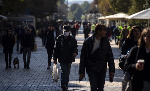 epa08758840 A man wearing a face mask walks on a street in Sofia, Bulgaria, 20 October 2020. According to official statistics of the health ministry, Bulgaria marks a new daily absolute record of posi ...