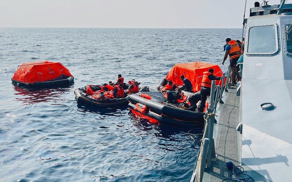 In this photo released by Sri Lankan President Media Division, Sri Lankan Navy sailors rescue Iranian sailors from IRIS Dena warship after their ship sank outside Sri Lanka's territorial waters,  ...