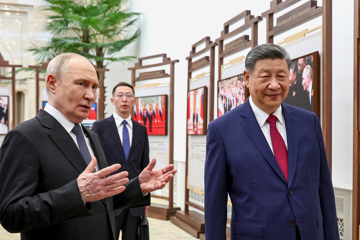 Russian President Vladimir Putin, left, and Chinese President Xi Jinping visit an exhibition by the TASS and Xinhua news agencies at the Great Hall of the People, in Beijing, China, on Wednesday, May  ...