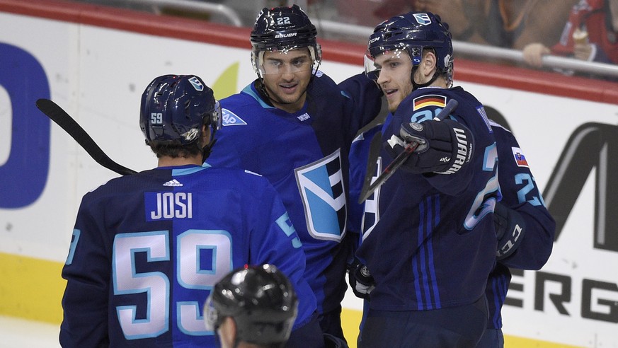 Europe forward Leon Draisaitl, right, of Germany, celebrates his goal against Sweden, with forward Nino Niederreiter (22), and defenseman Roman Josi (59), both of Switzerland, during the third period  ...