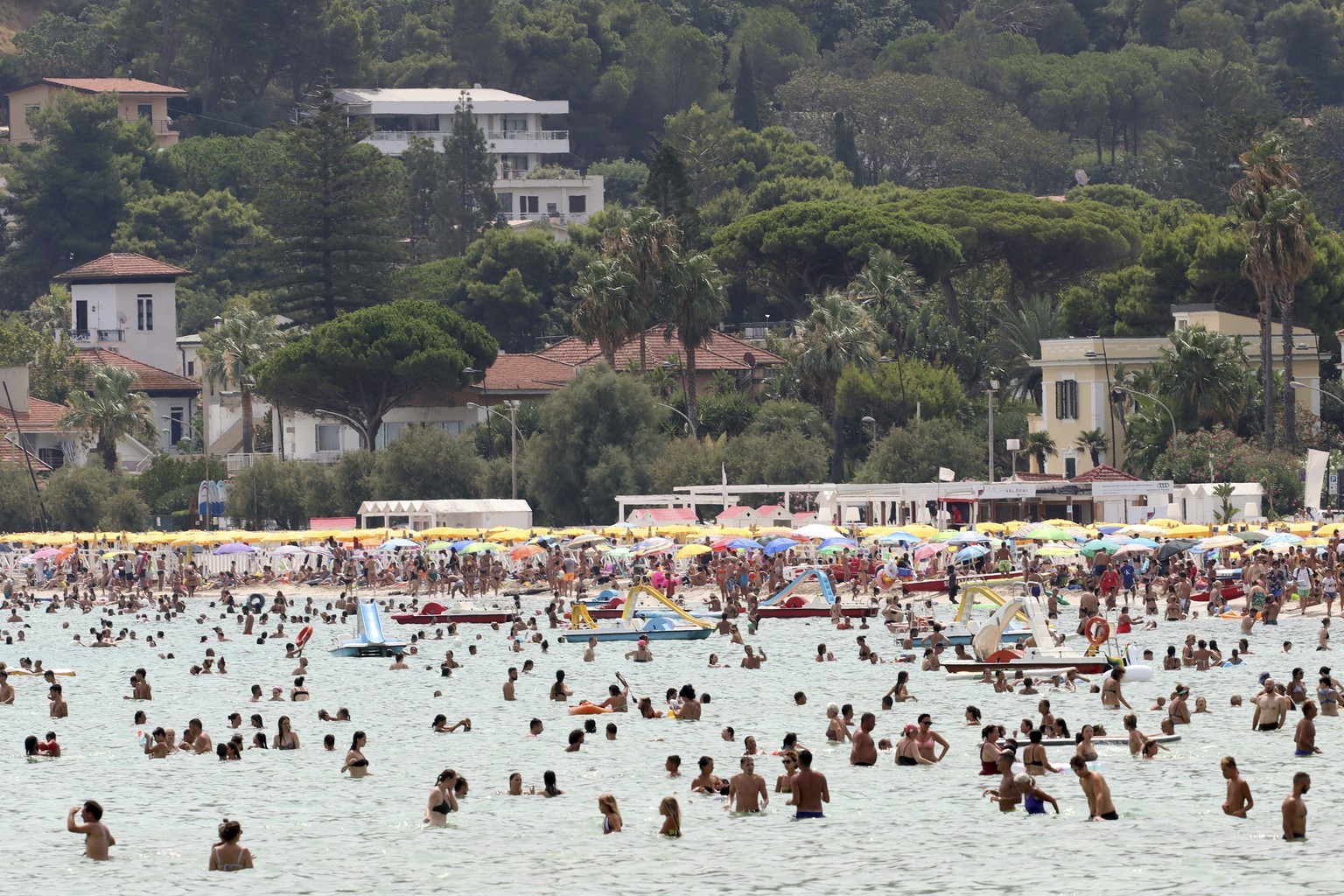 People refresh in the sea in Palermo, Sicily, Italy, Wednesday, Aug. 11, 2021. The ongoing heatwave will last up until the weekend with temperatures expected to reach well over 40 degrees Celsius in m ...