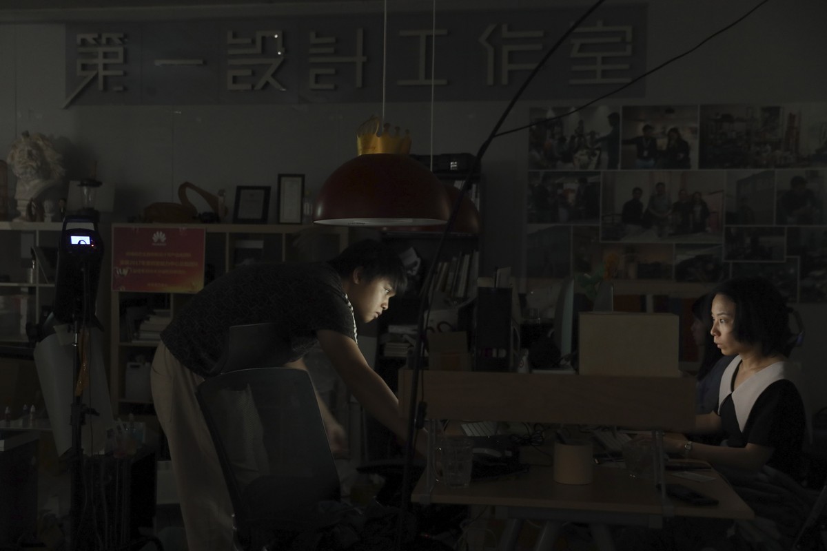 In this Aug. 19, 2019, photo, Huawei employees work at their computers at the User Centered Design lab at the Huawei Campus in Shenzhen in Southern China's Guangdong province. Facing a ban on acc ...