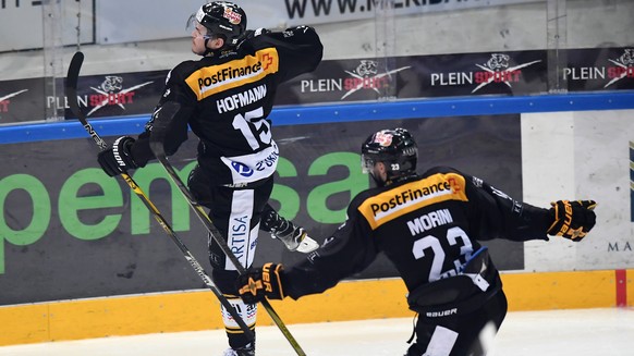 LuganoÃs player Gregory Hofmann, left, and LuganoÃs player Giovanni Morini, right, celebrate the 2-0 goal during the fifth match of the playoff final of the National League of the ice hockey Swiss C ...