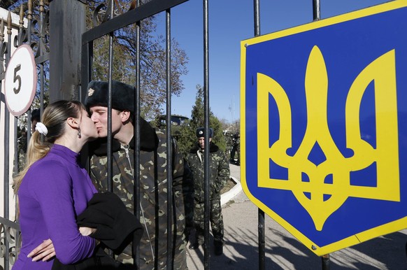 Ein ukrainischer Soldat küsst am 3. März aus der Militärbasis in dem Dorf Lyubimovka eine Frau.