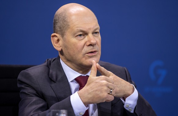 epa09763331 German Chancellor Olaf Scholz (SPD) at a press conference following the consultation with the heads of government of the federal states on the current situation of the coronavirus pandemic ...